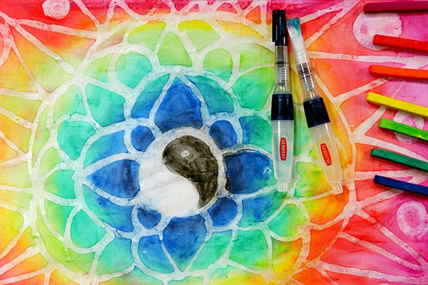 Colourful geometric art design with Derwent Inktense blocks laying on top