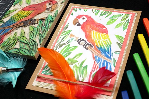 Block print of parrot next to carved stamp used to create the print